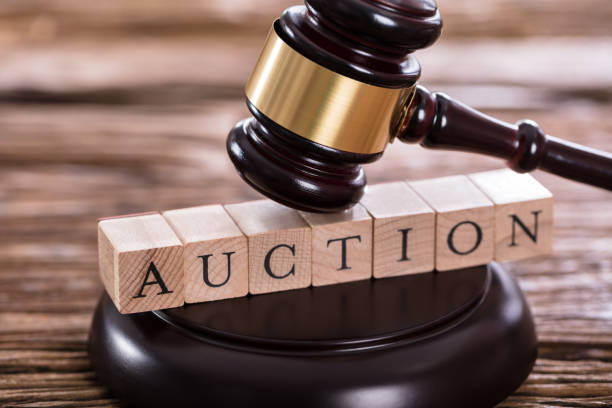 close up of a gavel striking on auction word